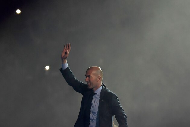 Real Madrid's French coach Zinedine Zidane aknowledges supporters at the Santiago Bernabeu stadium in Madrid on May 27, 2018 during a victory ceremony after Real Madrid won its third Champions League title in a row in Kiev. (Photo by OSCAR DEL POZO / AFP)        (Photo credit should read OSCAR DEL POZO/AFP/Getty Images)