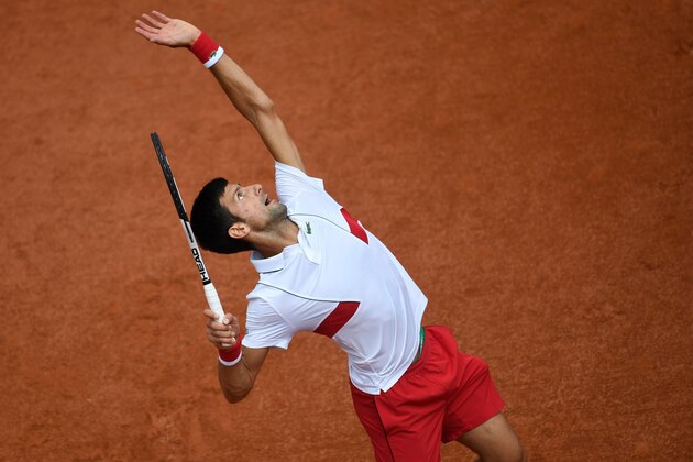 TOPSHOT - Serbia's Novak Djokovic serves to Spain's Jaume Munar during their men's singles second round match on day four of The Roland Garros 2018 French Open tennis tournament in Paris on May 30, 2018. (Photo by CHRISTOPHE SIMON / AFP)        (Photo credit should read CHRISTOPHE SIMON/AFP/Getty Images)