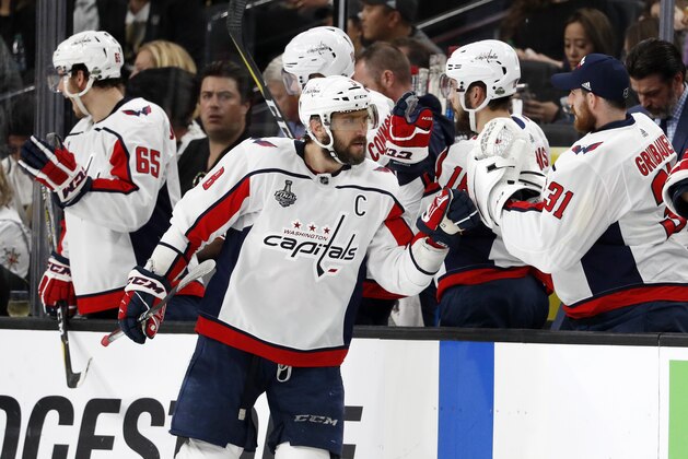 Washington Capitals left wing Alex Ovechkin, of Russia, celebrates his goal with teammates at the bench during the second period in Game 2 of the team's NHL hockey Stanley Cup Finals against the Vegas Golden Knights on Wednesday, May 30, 2018, in Las Vegas. (AP Photo/John Locher)