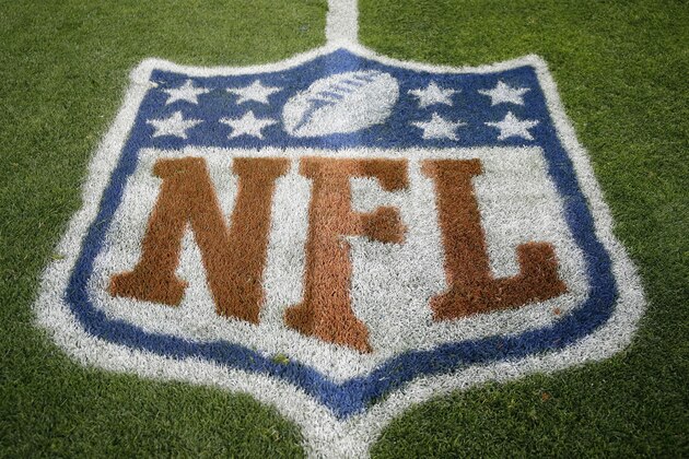 FILE - In this Nov. 12, 2017, file photo, an NFL logo is displayed on the field before an NFL football game between the New England Patriots and the Denver Broncos in Denver. Fox and the NFL have agreed to a five-year deal for Thursday night football games, Fox announced Wednesday, Jan. 31, 2018. Those games previously were televised by CBS and NBC, two of the league's other network partners.  (AP Photo/Jack Dempsey, File)