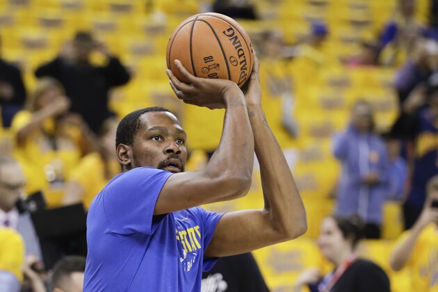 Golden State Warriors forward Kevin Durant warms up before Game 1 of basketball's NBA Finals between the Warriors and the Cleveland Cavaliers in Oakland, Calif., Thursday, May 31, 2018. (AP Photo/Marcio Jose Sanchez)