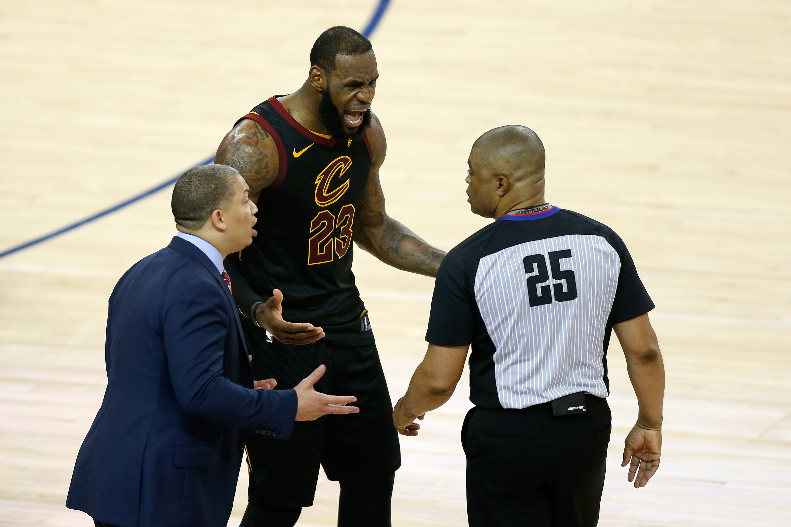 OAKLAND, CA - MAY 31:  LeBron James #23 and head coach Tyronn Lue of the Cleveland Cavaliers argue with referee Tony Brothers #25 against the Golden State Warriors in Game 1 of the 2018 NBA Finals at ORACLE Arena on May 31, 2018 in Oakland, California. NOTE TO USER: User expressly acknowledges and agrees that, by downloading and or using this photograph, User is consenting to the terms and conditions of the Getty Images License Agreement.  (Photo by Lachlan Cunningham/Getty Images)