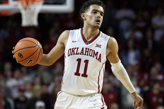 FILE - In this Feb. 17, 2018, file photo, Oklahoma guard Trae Young (11) brings the ball up court during the second half of an NCAA college basketball game against Texas, in Norman, Okla. Trae Young has had one of the best freshman seasons in NCAA history. His decision on whether to go pro or not looms.  (AP Photo/Sue Ogrocki, File)