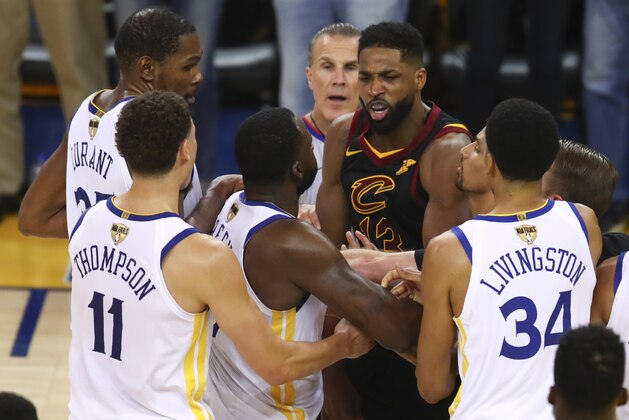 Cleveland Cavaliers center Tristan Thompson, facing, confronts Golden State Warriors forward Draymond Green, second from bottom left, during overtime of Game 1 of basketball's NBA Finals in Oakland, Calif., Thursday, May 31, 2018. The Warriors won 124-114. (AP Photo/Ben Margot)