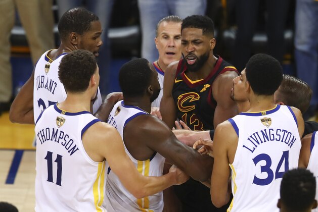 Cleveland Cavaliers center Tristan Thompson, facing, confronts Golden State Warriors forward Draymond Green, second from bottom left, during overtime of Game 1 of basketball's NBA Finals in Oakland, Calif., Thursday, May 31, 2018. The Warriors won 124-114. (AP Photo/Ben Margot)