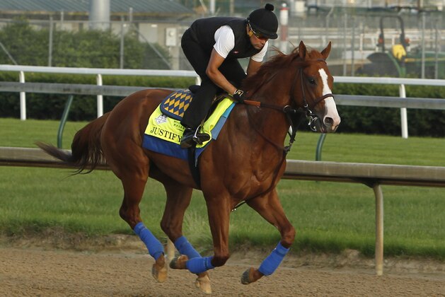 Justify, ridden by exercise rider Humberto Gomez, gallops at Churchill Downs in Louisville, Ky., Saturday, May 26, 2018 getting ready for The Belmont Stakes and a possible Triple Crown, in New York in June. (AP Photo/Garry Jones)