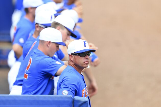 FILE - In this June 12, 2017, file photo, Florida head coach Kevin O'Sullivan, foreground, watches from the dugout during an NCAA college super regional baseball game against Wake Forest, in Gainesville, Fla. The top-seeded and defending national champion Gators (42-17) begin regional play Friday having lost six of their last seven, all since clinching the Southeastern Conference’s regular-season title. (AP Photo/Matt Stamey, File)