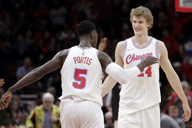 Chicago Bulls' Bobby Portis (5) and Lauri Markkanen celebrates Markkanen's clutch score late in the second half of an NBA basketball game against the Dallas Mavericks, Friday, March 2, 2018, in Chicago. (AP Photo/Charles Rex Arbogast)