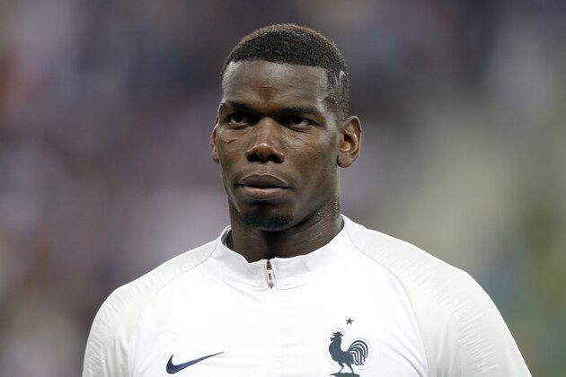 France's Paul Pogba listens to the national anthems before a friendly soccer match between France and Italy at the Allianz Riviera stadium in Nice, southern France, Friday, June 1, 2018. (AP Photo/Claude Paris)