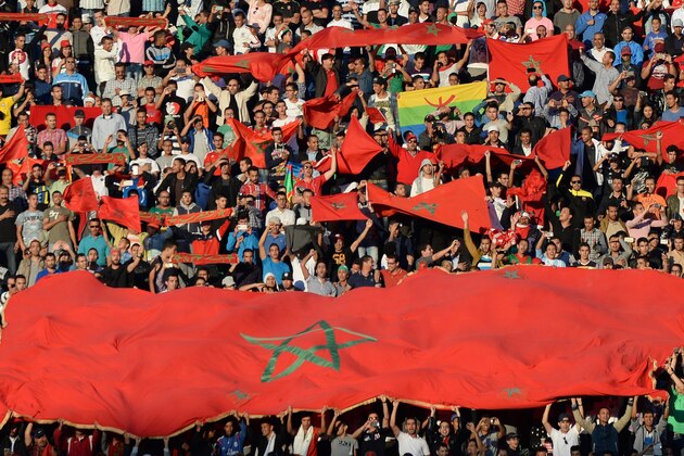 Maroccan supporters hold flags during the 2017 Africa Cup of Nations qualifying football match against Libya in Agadir on June 12, 2015. AFP PHOTO / FADEL SENNA        (Photo credit should read FADEL SENNA/AFP/Getty Images)
