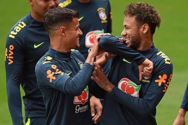 Brazil's midfielder Philippe Coutinho (L) and Brazil's striker Neymar share a joke as they take part in a training session at Anfield stadium in Liverpool on June 2, 2018, ahead their International friendly football match against Croatia. (Photo by Oli SCARFF / AFP)        (Photo credit should read OLI SCARFF/AFP/Getty Images)