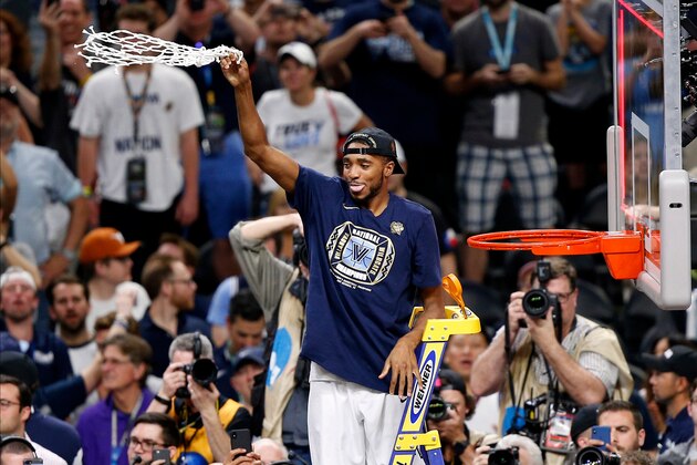 Villanova guard Mikal Bridges celebrates after cutting down the net after the championship game against Michigan in the Final Four NCAA college basketball tournament, Monday, April 2, 2018, in San Antonio. Villanova won 79-62. (AP Photo/Brynn Anderson)