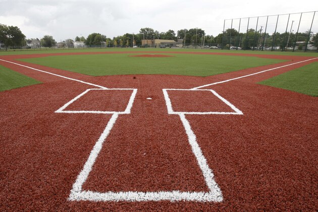 This Thursday, Aug. 21, 2014 photo shows the restored field at League Park in Cleveland. The city of Cleveland has invested $6.3 million in restoring the old site of League Park, a historic site where the Cleveland Indians clinched its 1920 World Series title, Babe Ruth hit his 500th home run and where Joe DiMaggio extended his hitting streak to 56 games. Not much of the old ballbark, where Cy Young threw the first pitch in 1891 remains, but the new park will host high school and youth games on its all-turf field and will pay homage to the greats who once played there. (AP Photo/Tony Dejak)