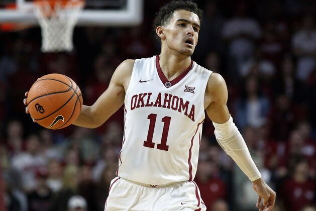 FILE - In this Feb. 17, 2018, file photo, Oklahoma guard Trae Young (11) brings the ball up court during the second half of an NCAA college basketball game against Texas, in Norman, Okla. Trae Young has had one of the best freshman seasons in NCAA history. His decision on whether to go pro or not looms.  (AP Photo/Sue Ogrocki, File)