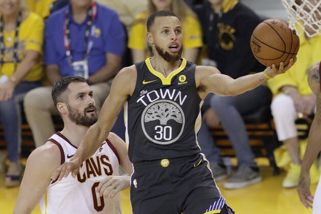 Golden State Warriors guard Stephen Curry (30) shoots against Cleveland Cavaliers forward Kevin Love (0) during the first half of Game 2 of basketball's NBA Finals in Oakland, Calif., Sunday, June 3, 2018. (AP Photo/Marcio Jose Sanchez)