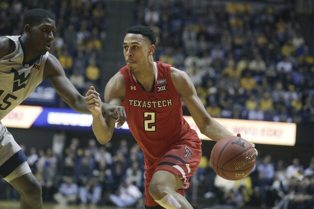 Texas Tech guard Zhaire Smith (2) drives while defended by West Virginia forward Lamont West (15) during the first half of an NCAA college basketball game Monday, Feb. 26, 2018, in Morgantown, W.Va. (AP Photo/Raymond Thompson)