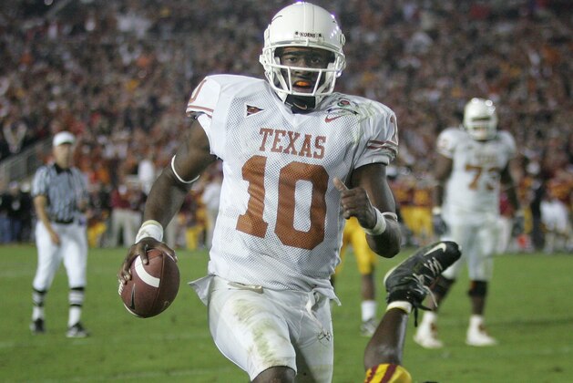 FILE - In this Jan. 4, 2006, file photo, Texas quarterback Vince Young rushes for the game-winning touchdown against Southern California during the Rose Bowl college football game in Pasadena, Calif. USC’s run at No. 1 ended in the 2006 Rose Bowl, which was also one of the best games of the decade. Texas _ led by coach Mack Brown and quarterback Vince Young _ topped the Trojans 41-38 in a back-and-forth thriller. (AP Photo/Paul Sakuma, File)