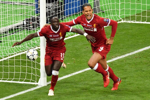 TOPSHOT - Liverpool's Senegalese midfielder Sadio Mane (L) celebrates with his teammate Liverpool's Dutch defender Virgil Van Dijk after scoring the 1-1 during the UEFA Champions League final football match between Liverpool and Real Madrid at the Olympic Stadium in Kiev, Ukraine on May 26, 2018. (Photo by Sergei SUPINSKY / AFP) (Photo credit should read SERGEI SUPINSKY/AFP/Getty Images) TOPSHOT - Liverpool's Senegalese midfielder Sadio Mane (L) celebrates with his teammate Liverpool's Dutch defender Virgil Van Dijk after scoring the 1-1 during the UEFA Champions League final football match between Liverpool and Real Madrid at the Olympic Stadium in Kiev, Ukraine on May 26, 2018. (Photo by Sergei SUPINSKY / AFP) (Photo credit should read SERGEI SUPINSKY/AFP/Getty Images)