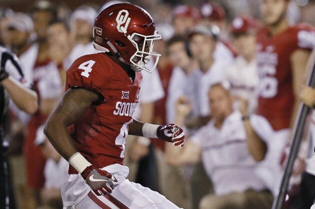 In this Saturday, Sept. 17, 2016 photo, Oklahoma cornerback Parrish Cobb, left, chases Ohio State's Curtis Samuel, right, out of bounds during an NCAA college football game in Norman, Okla. Police say Cobb turned himself in after authorities issued an arrest warrant for aggravated robbery in his Texas hometown of Waco, Texas. Cobb has been suspended by the Sooners and his attorney says he is looking forward to addressing the allegations. (AP Photo/Sue Ogrocki) In this Saturday, Sept. 17, 2016 photo, Oklahoma cornerback Parrish Cobb, left, chases Ohio State's Curtis Samuel, right, out of bounds during an NCAA college football game in Norman, Okla. Police say Cobb turned himself in after authorities issued an arrest warrant for aggravated robbery in his Texas hometown of Waco, Texas. Cobb has been suspended by the Sooners and his attorney says he is looking forward to addressing the allegations. (AP Photo/Sue Ogrocki)