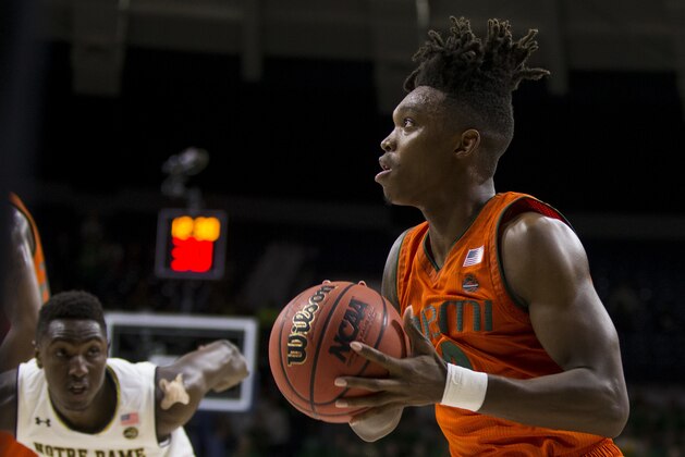 Miami's Lonnie Walker IV, right, sets up for a shot in front of Notre Dame's T.J. Gibbs (10) during the first half of an NCAA college basketball game Monday, Feb. 19, 2018, in South Bend, Ind. Miami won 77-74. (AP Photo/Robert Franklin)