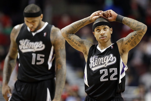 Sacramento Kings guard Isaiah Thomas, right, reacts after center DeMarcus Cousins (15) fouled Chicago Bulls guard Mike Dunleavy during the second half of an NBA basketball game in Chicago on Saturday, March 15, 2014. The Bulls won 94-87. (AP Photo/Nam Y. Huh)
