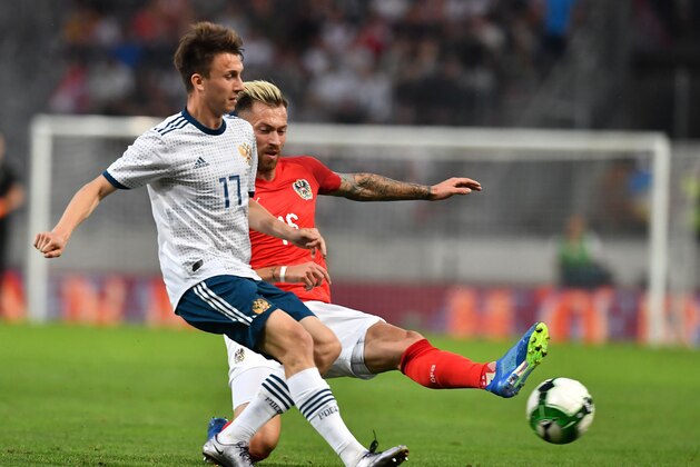 Russia's Aleksandr Golovin (l) and Austria's Peter Zulj vie for a ball during their international friendly football match between Austria and Russia at Tivoli stadium in Innsbruck, Austria on May 30, 2018. (Photo by JOE KLAMAR / AFP)        (Photo credit should read JOE KLAMAR/AFP/Getty Images)