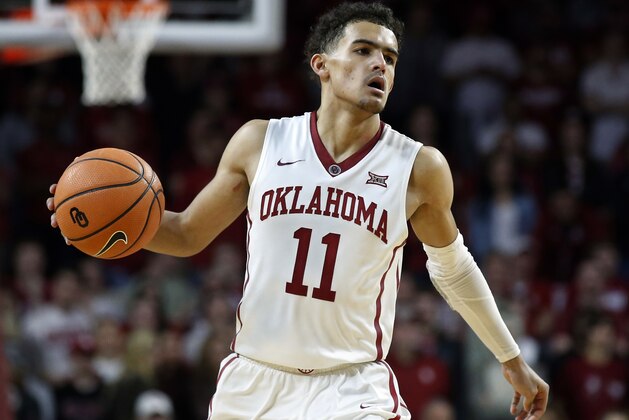 FILE - In this Feb. 17, 2018, file photo, Oklahoma guard Trae Young (11) brings the ball up court during the second half of an NCAA college basketball game against Texas, in Norman, Okla. Trae Young has had one of the best freshman seasons in NCAA history. His decision on whether to go pro or not looms.  (AP Photo/Sue Ogrocki, File)