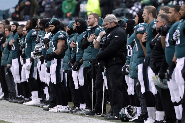 Philadelphia Eagles' Carson Wentz center, listens to the national anthem before an NFL football game against the Dallas Cowboys, Sunday, Dec. 31, 2017, in Philadelphia. (AP Photo/Michael Perez)