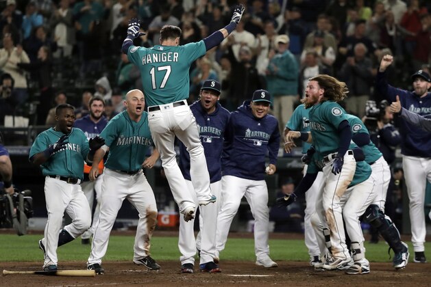 Seattle Mariners' Mitch Haniger (17) leaps onto home plate after he hit a walk-off home run against the Tampa Bay Rays during the 13th inning of a baseball game, Friday, June 1, 2018, in Seattle. The Mariners won 4-3 in 13 innings. (AP Photo/Ted S. Warren) Seattle Mariners' Mitch Haniger (17) leaps onto home plate after he hit a walk-off home run against the Tampa Bay Rays during the 13th inning of a baseball game, Friday, June 1, 2018, in Seattle. The Mariners won 4-3 in 13 innings. (AP Photo/Ted S. Warren)