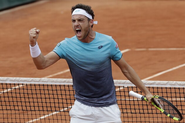 Italy's Marco Cecchinato celebrates winning the second set against Serbia's Novak Djokovic during their quarterfinal match of the French Open tennis tournament at the Roland Garros stadium in Paris, France, Tuesday, June 5, 2018. (AP Photo/Alessandra Tarantino)
