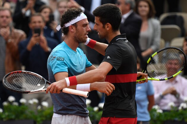 Italy's Marco Cecchinato (L) embraces as he celebrates after victory over Serbia's Novak Djokovic during their men's singles quarter-final match on day ten of The Roland Garros 2018 French Open tennis tournament in Paris on June 5, 2018. (Photo by Eric FEFERBERG / AFP)        (Photo credit should read ERIC FEFERBERG/AFP/Getty Images)