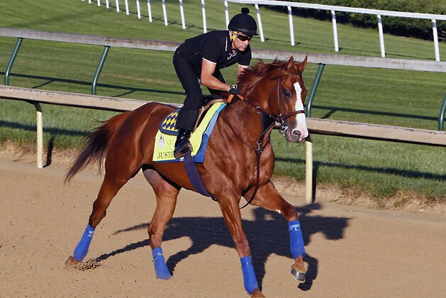 Justify, Kentucky Derby and Preakness Stakes winner, ridden by exercise rider Humberto Gomez, puts in a morning gallop at Churchill Downs in Louisville, Ky., Friday, May 25, 2018. (AP Photo/Garry Jones)