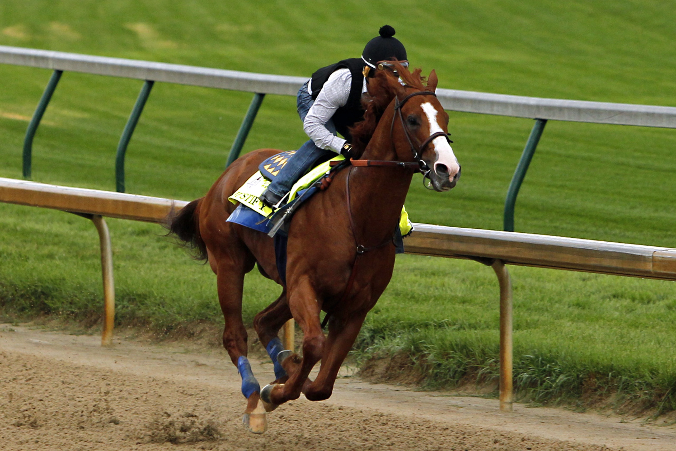 Jockey Martin Garcia works Triple Crown hopeful Justify at Churchill Downs in Louisville, Ky., Tuesday, May 29, 2018. (AP Photo/Garry Jones)