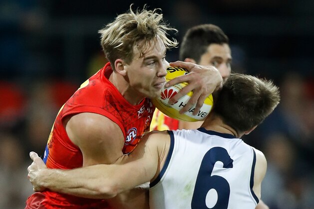 GOLD COAST, AUSTRALIA - JUNE 02: Tom Lynch of the Sunsis tackled by Lincoln McCarthy of the Cats during the 2018 AFL round 11 match between the Gold Coast Suns and the Geelong Cats at Metricon Stadium on June 02, 2018 on the Gold Coast, Australia. (Photo by Michael Willson/AFL Media/Getty Images)
