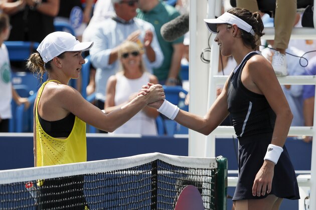 Garbine Muguruza, of Spain, right, shakes hands with Simona Halep, of Romania, after winning the women's singles final at the Western & Southern Open, Sunday, Aug. 20, 2017, in Mason, Ohio. Muguruza won 6-1, 6-0. (AP Photo/John Minchillo)