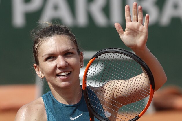 Romania's Simona Halep waves to the crowd after defeating Germany's Angelique Kerber after their quarterfinal match of the French Open tennis tournament at the Roland Garros stadium, Wednesday, June 6, 2018 in Paris. Halep won 6-7 (2), 6-3, 6-2. (AP Photo/Alessandra Tarantino)