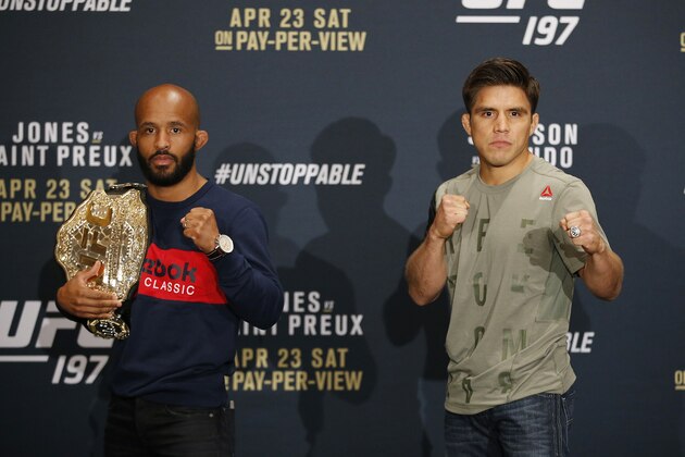 Demetrious Johnson, left, and Henry Cejudo pose during the UFC 197 mixed martial arts news conference, Thursday, April 21, 2016, in Las Vegas. The two are scheduled to fight in a flyweight title fight Saturday in Las Vegas. (AP Photo/John Locher)