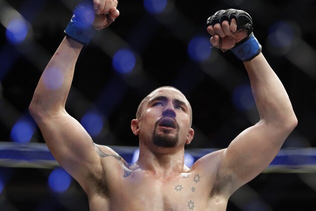 Robert Whittaker celebrates after defeating Yoel Romero in a middleweight championship mixed martial arts bout at UFC 213, Saturday, July 8, 2017, in Las Vegas. (AP Photo/John Locher)