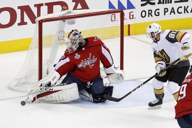 Washington Capitals goaltender Braden Holtby, left, turns the puck away as Vegas Golden Knights forward Jonathan Marchessault (81) closes in during the first period in Game 4 of the NHL hockey Stanley Cup Final, Monday, June 4, 2018, in Washington. (AP Photo/Pablo Martinez Monsivais)