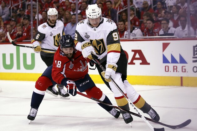 Washington Capitals forward Chandler Stephenson (18) defends against Vegas Golden Knights forward Tomas Nosek (92), of the Czech Republic, during the second period in Game 4 of the NHL hockey Stanley Cup Final, Monday, June 4, 2018, in Washington. (AP Photo/Alex Brandon)