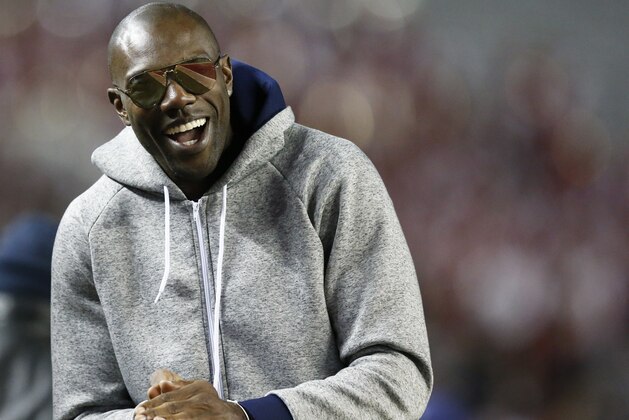 Former NFL wide receiver and Chattanooga alum Terrell Owens walks the sidelines during the second half of an NCAA college football game with Alabama and Chattanooga, Saturday, Nov. 19, 2016, in Tuscaloosa, Ala. (AP Photo/Brynn Anderson)