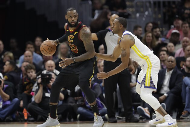 Golden State Warriors forward Andre Iguodala (9) defends Cleveland Cavaliers forward LeBron James (23) in the first half of Game 3 of basketball's NBA Finals, Wednesday, June 6, 2018, in Cleveland. (AP Photo/Tony Dejak)