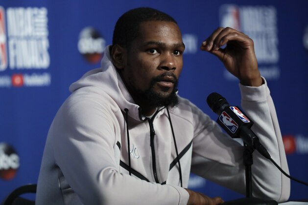 Golden State Warriors forward Kevin Durant attends a news conference following Game 3 of basketball's NBA Finals, early Wednesday June 7, 2018, in Cleveland. The Warriors defeated the Cleveland Cavaliers 110-102 to take a 3-0 lead in the series. (AP Photo/Tony Dejak)