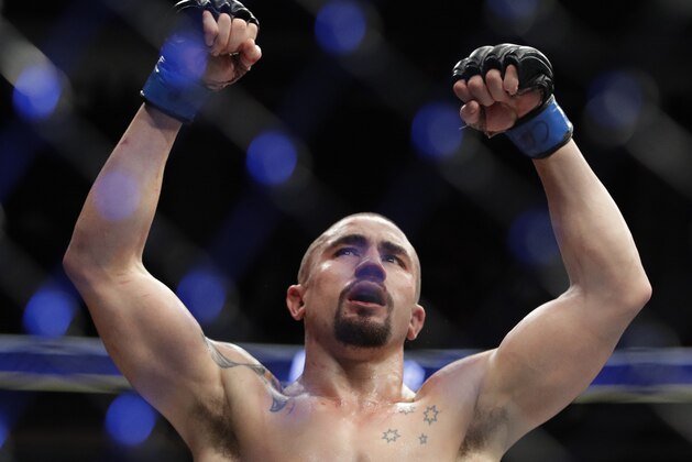 Robert Whittaker celebrates after defeating Yoel Romero in a middleweight championship mixed martial arts bout at UFC 213, Saturday, July 8, 2017, in Las Vegas. (AP Photo/John Locher)
