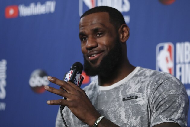 Cleveland Cavaliers forward LeBron James takes questions at a press conference after the basketball team's practiced during the NBA Finals, Thursday, June 7, 2018, in Cleveland. The Warriors lead the series 3-0 with Game 4 on Friday. (AP Photo/Carlos Osorio)