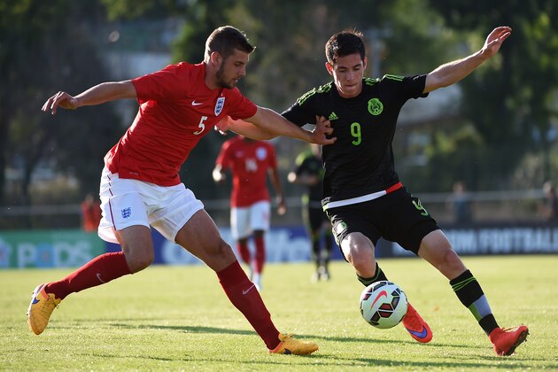 England's Jack Stephens (L) vies with Mexico's Marco Bueno during the U-21 international football match between Mexico and England as part of the Festival International Espoirs tournament at the De Lattre stadium in Aubagne, southern France, on June 3, 2015. AFP PHOTO / ANNE-CHRISTINE POUJOULAT        (Photo credit should read ANNE-CHRISTINE POUJOULAT/AFP/Getty Images)