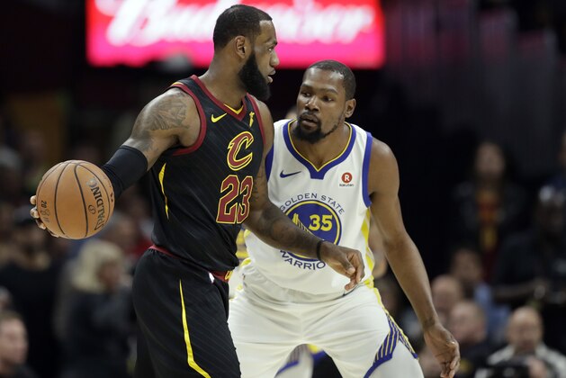 Cleveland Cavaliers' LeBron James is defended by Golden State Warriors' Kevin Durant in the first half of Game 3 of basketball's NBA Finals, Wednesday, June 6, 2018, in Cleveland. (AP Photo/Tony Dejak)