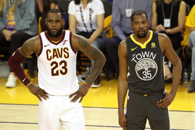 OAKLAND, CA - JUNE 3:  LeBron James #23 of the Cleveland Cavaliers and Kevin Durant #35 of the Golden State Warriors look on in Game Two of the 2018 NBA Finals on June 3, 2018 at ORACLE Arena in Oakland, California. NOTE TO USER: User expressly acknowledges and agrees that, by downloading and/or using this photograph, user is consenting to the terms and conditions of the Getty Images License Agreement. Mandatory Copyright Notice: Copyright 2018 NBAE (Photo by Joe Murphy/NBAE via Getty Images)