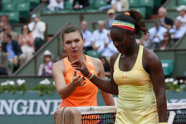 Romania's Simona Halep (L) is congratulated by USA's Sloane Stephens at the end of their French tennis Open round of sixteen match at the Roland Garros stadium in Paris on June 2, 2014.  AFP PHOTO / PATRICK KOVARIK        (Photo credit should read PATRICK KOVARIK/AFP/Getty Images)
