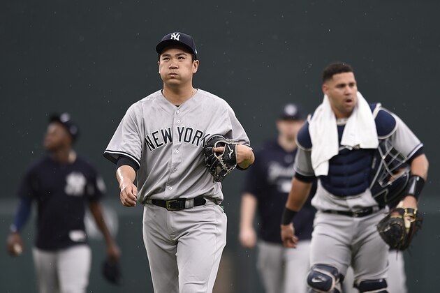 New York Yankees pitcher Masahiro Tanaka, center, walks to the dugout from the bullpen before playing the Baltimore Orioles in a baseball game, Saturday, June 2, 2018, in Baltimore. (AP Photo/Gail Burton)